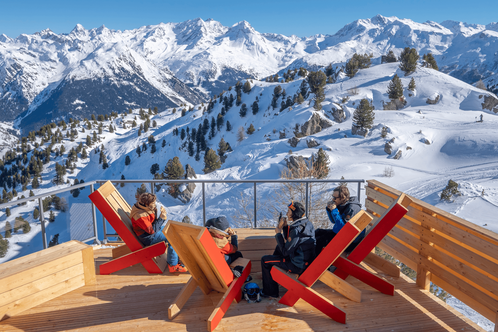 Family of skiers taking a break to eat lunch above Les Arcs ski resort